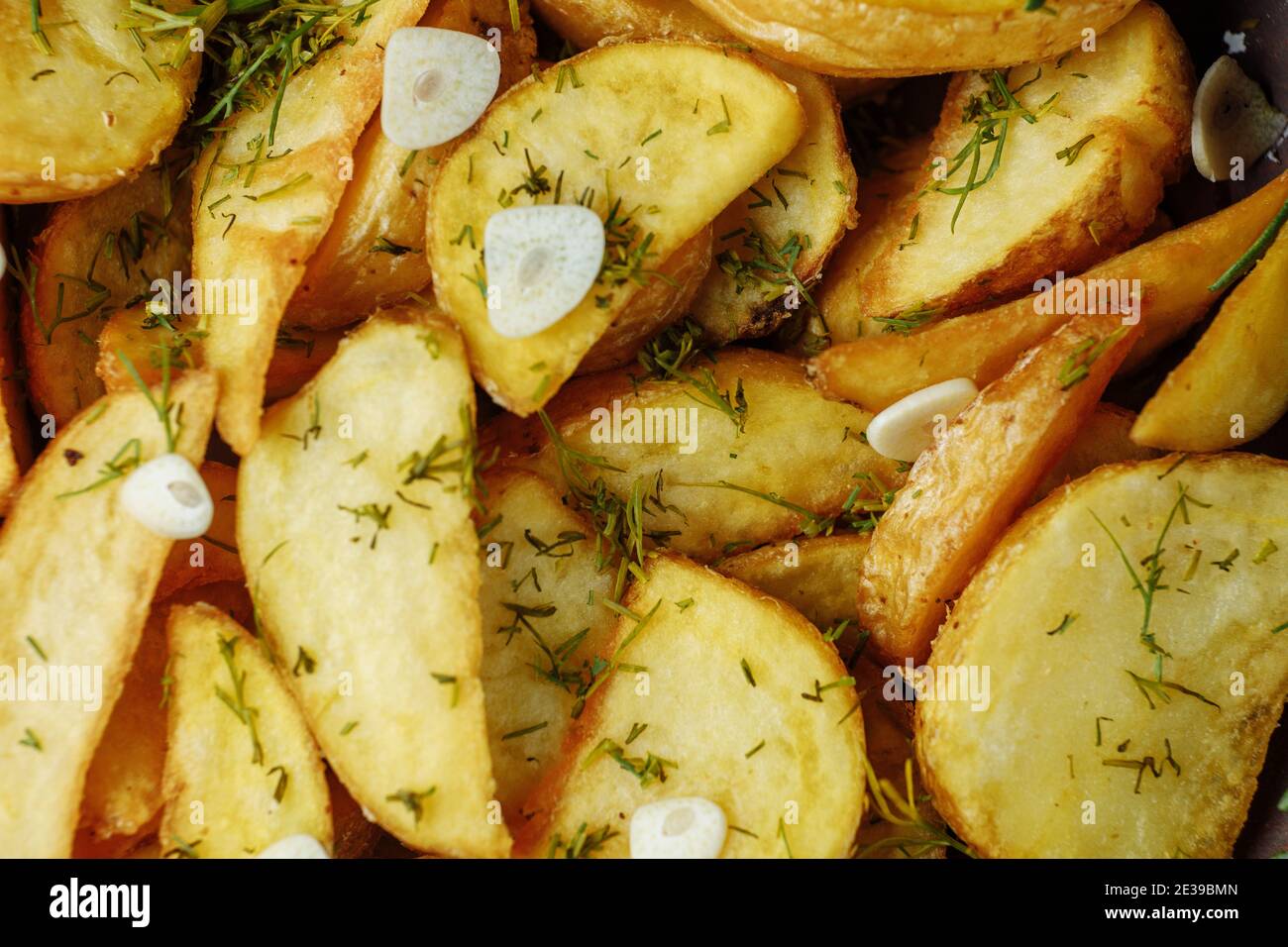 roasted rosemary garlic potato wedges on a plate Stock Photo Alamy