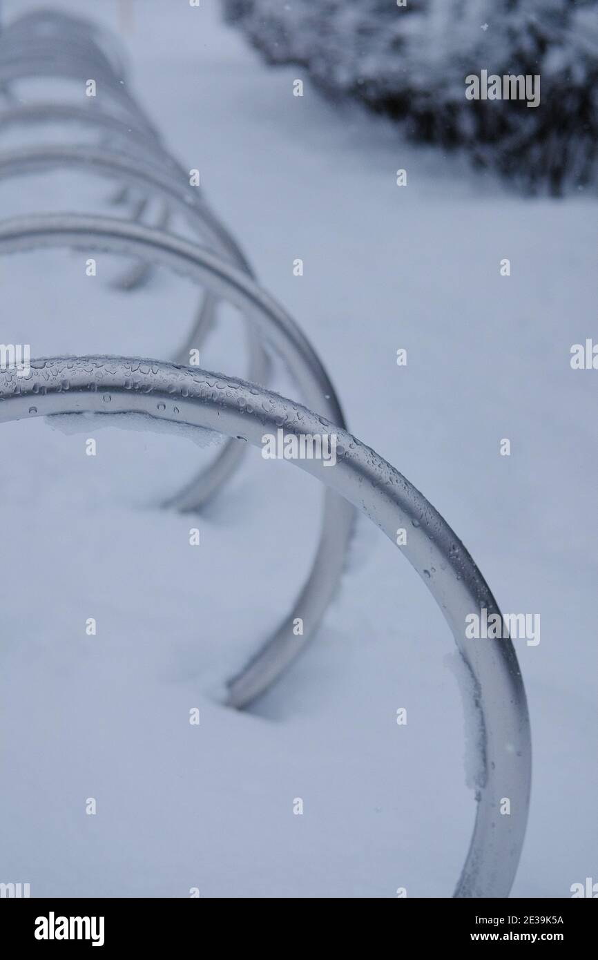 Bicycle parking shiny steel O racks in the fresh snow in Ottawa, Ontario, Canada. Stock Photo