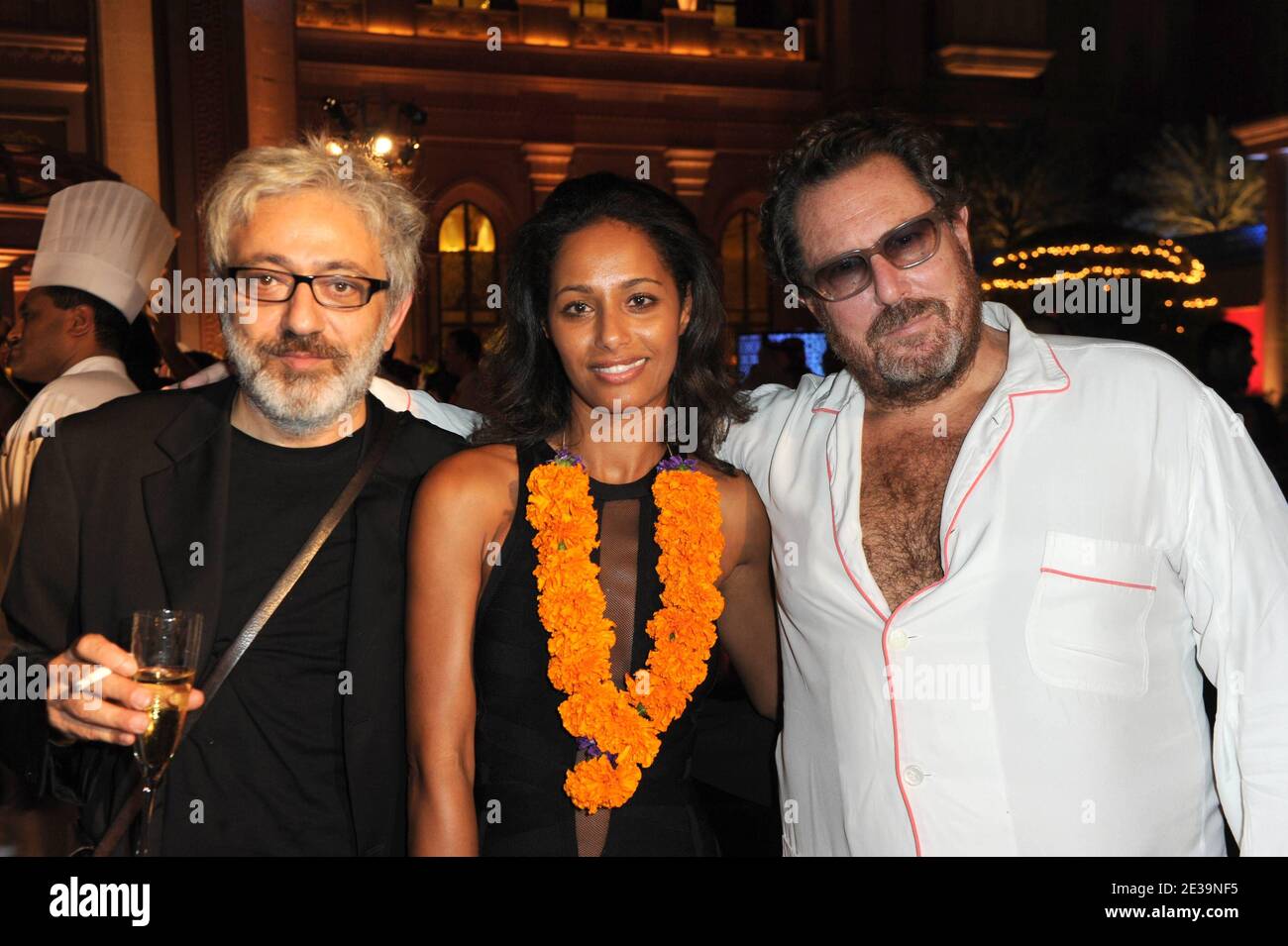 Palestinian director Elia Suleiman (L), journalist-writer Rula Jebreal (C)  and U.S. director Julian Schnabel in his famous pyjamas (R) seen at a party  at the Abu Dhabi Interntional Film Festival in Abu