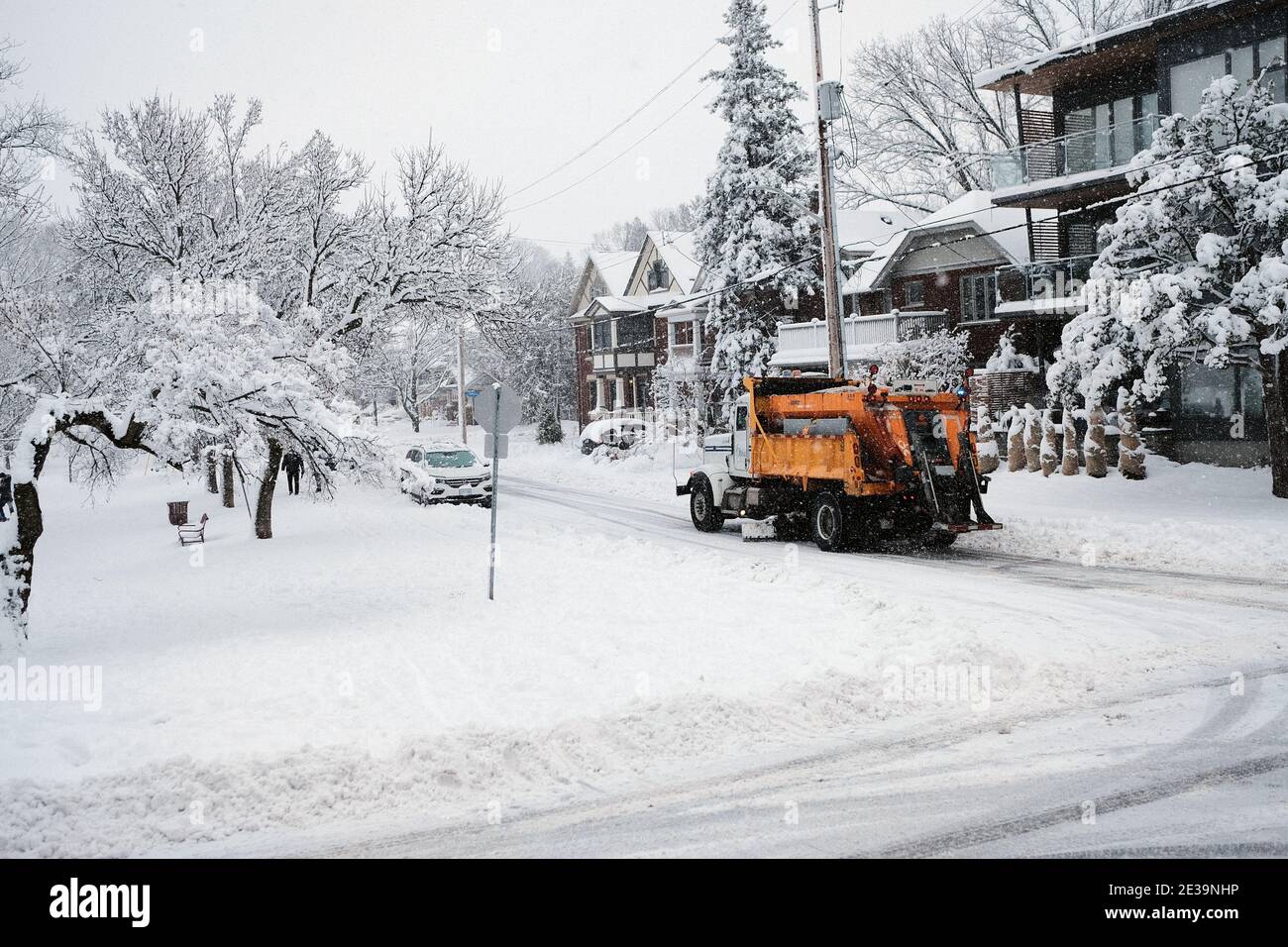 A yellow City of Ottawa snow plow truck roams the Glebe streets during a fresh dumping of 25cm