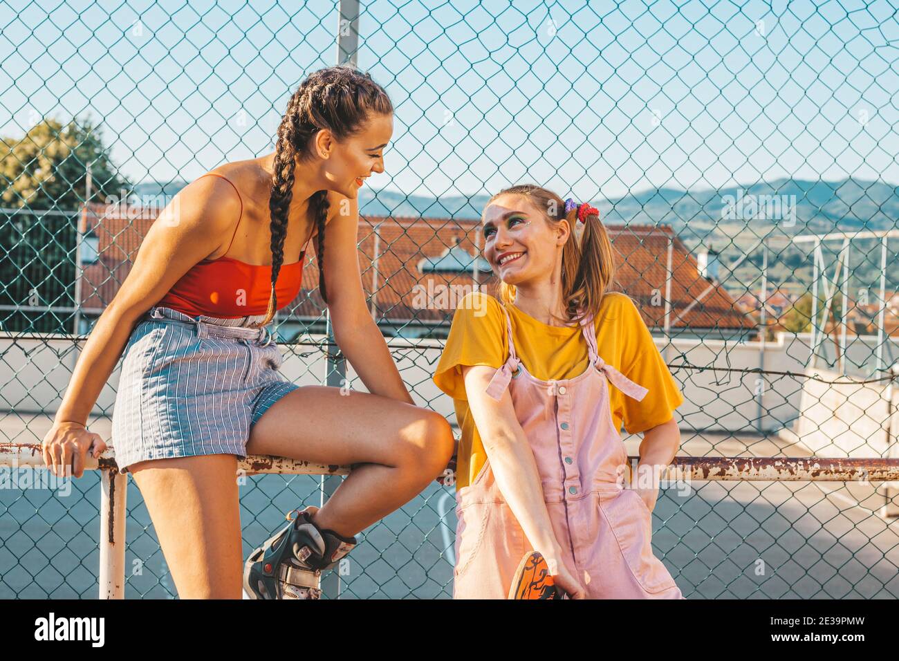 Two teen girls having a casual conversation. Urban style Stock Photo