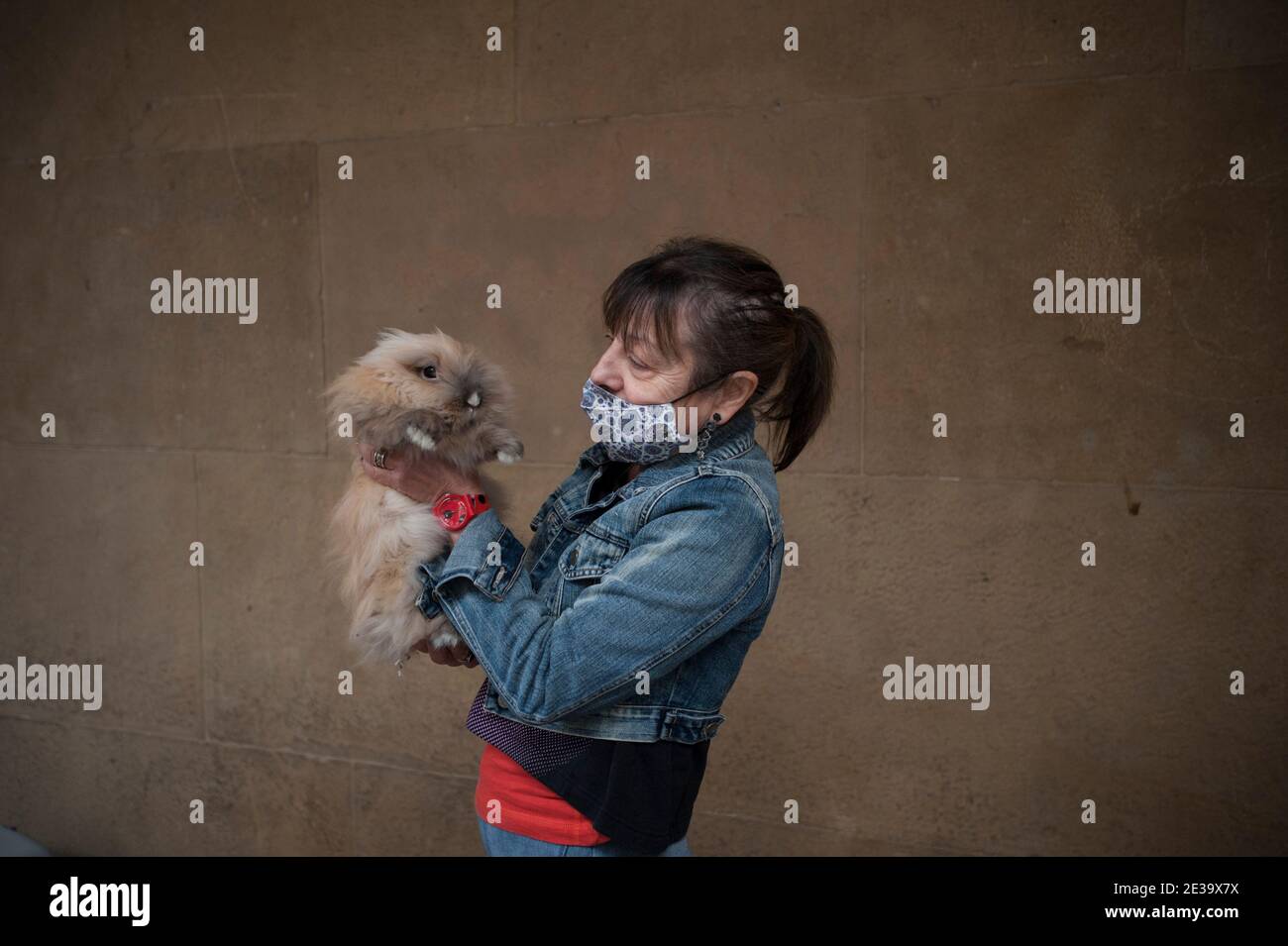 A lady who owns her one year old Angora rabbit awaiting the blessing by ...