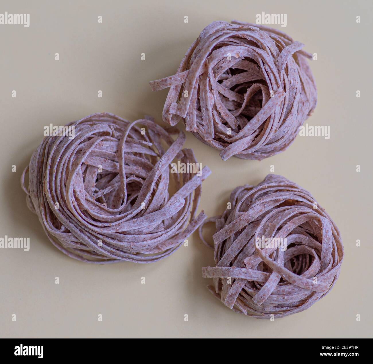 Raw whole grain brown pasta. Delicate wholemeal pasta made of graham