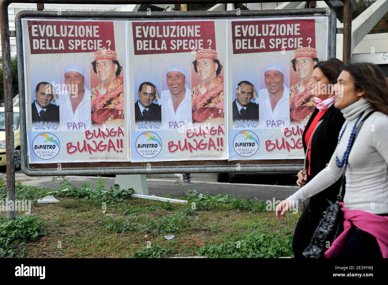 'Hundred of posters showing a ridiculous Silvio Berlusconi are invading in Rome, Italy, on October 30,2010. Writen : ' The evolution of the human race: Silvio, Papi, Bunga Bunga'. A high-profile Silvio Berlusconi political appointment has been drawn into a prostitution investigation involving a teenage Moroccan belly dancer. Prime Minister Silvio Berlusconi said he loved life and women and would not apologise for enjoying himself after new reports of young women and parties were splashed across the front pages. Italian newspapers have reported that a 17 year-old Moroccan girl, Karima El Mahrou Stock Photo