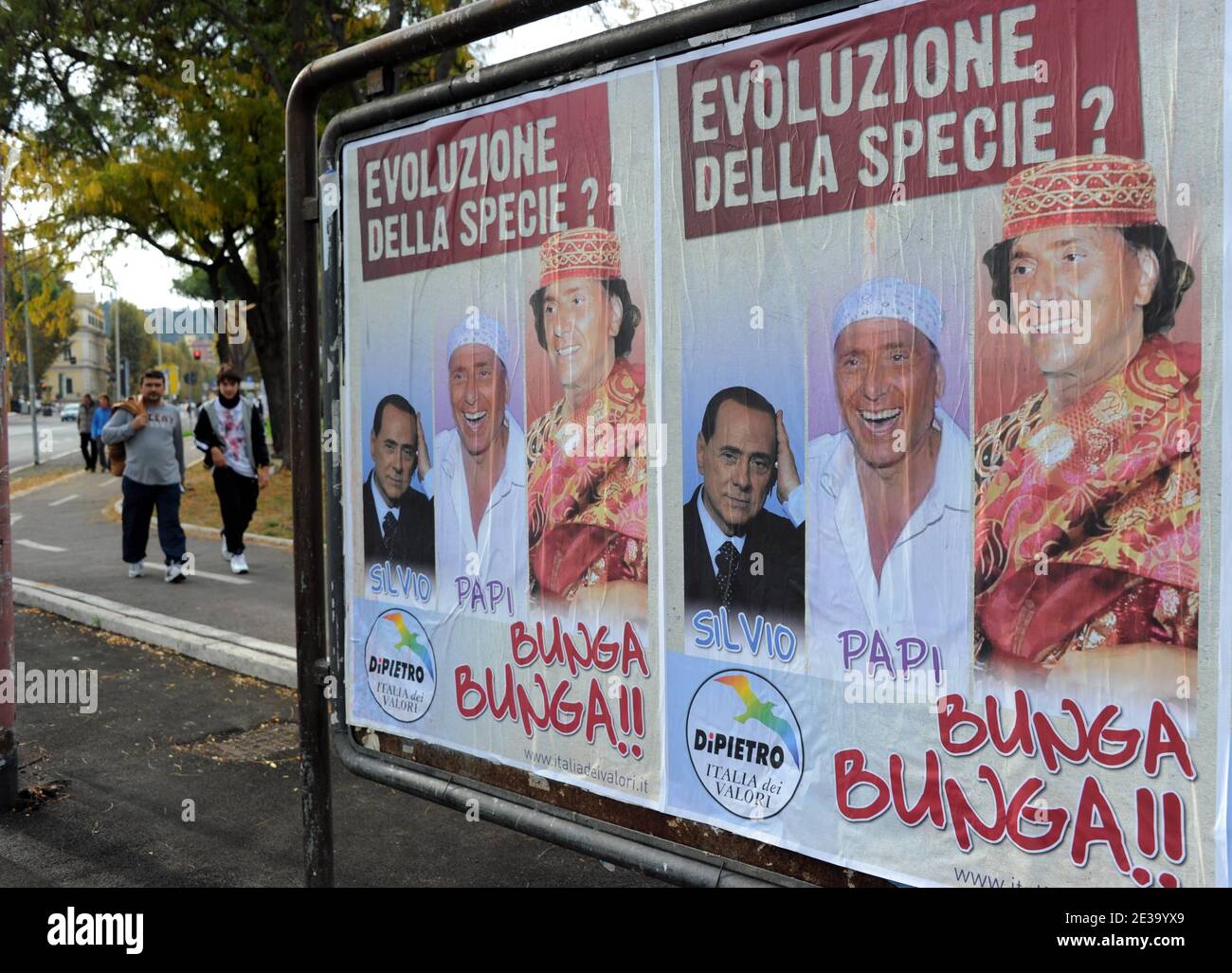 'Hundred of posters showing a ridiculous Silvio Berlusconi are invading in Rome, Italy, on October 30,2010. Writen : ' The evolution of the human race: Silvio, Papi, Bunga Bunga'. A high-profile Silvio Berlusconi political appointment has been drawn into a prostitution investigation involving a teenage Moroccan belly dancer. Prime Minister Silvio Berlusconi said he loved life and women and would not apologise for enjoying himself after new reports of young women and parties were splashed across the front pages. Italian newspapers have reported that a 17 year-old Moroccan girl, Karima El Mahrou Stock Photo