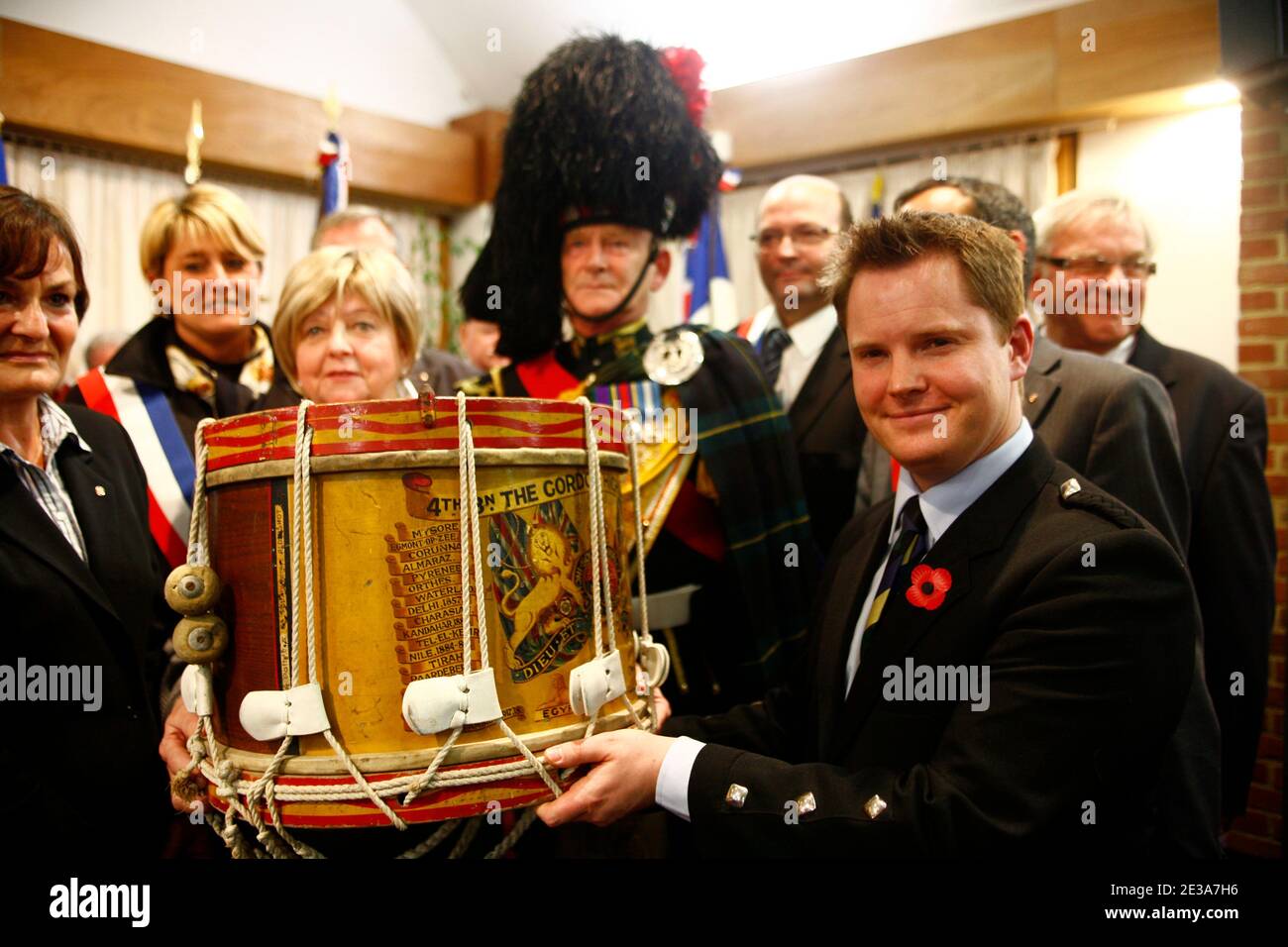 Pascale Osson (L) a desendant of French policeman, Seraphin Boulet, presents the Gordon Highlanders drum, which was was buried in a farmer's field by a British soldier of the 4th Battalion as the Gordons, during the British Army's retreat to Dunkirk in the Second World War, to curator, Jesper Ericsson (R) and representatives of the Gordon Highlanders Museum based in Aberdeen, Scotland, at a ceremony held in Hem, northern France on 12 November 2010. Media reports state that it has been revealed that, within hours of the 4th Battalion as the Gordons leaving the village of Hem in northern France, Stock Photo