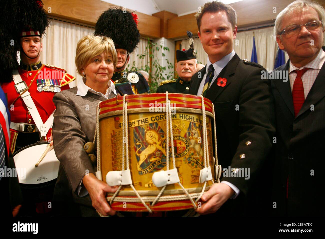 Pascale Osson (L) a desendant of French policeman, Seraphin Boulet, presents the Gordon Highlanders drum, which was was buried in a farmer's field by a British soldier of the 4th Battalion as the Gordons, during the British Army's retreat to Dunkirk in the Second World War, to curator, Jesper Ericsson (R) and representatives of the Gordon Highlanders Museum based in Aberdeen, Scotland, at a ceremony held in Hem, northern France on 12 November 2010. Media reports state that it has been revealed that, within hours of the 4th Battalion as the Gordons leaving the village of Hem in northern France, Stock Photo