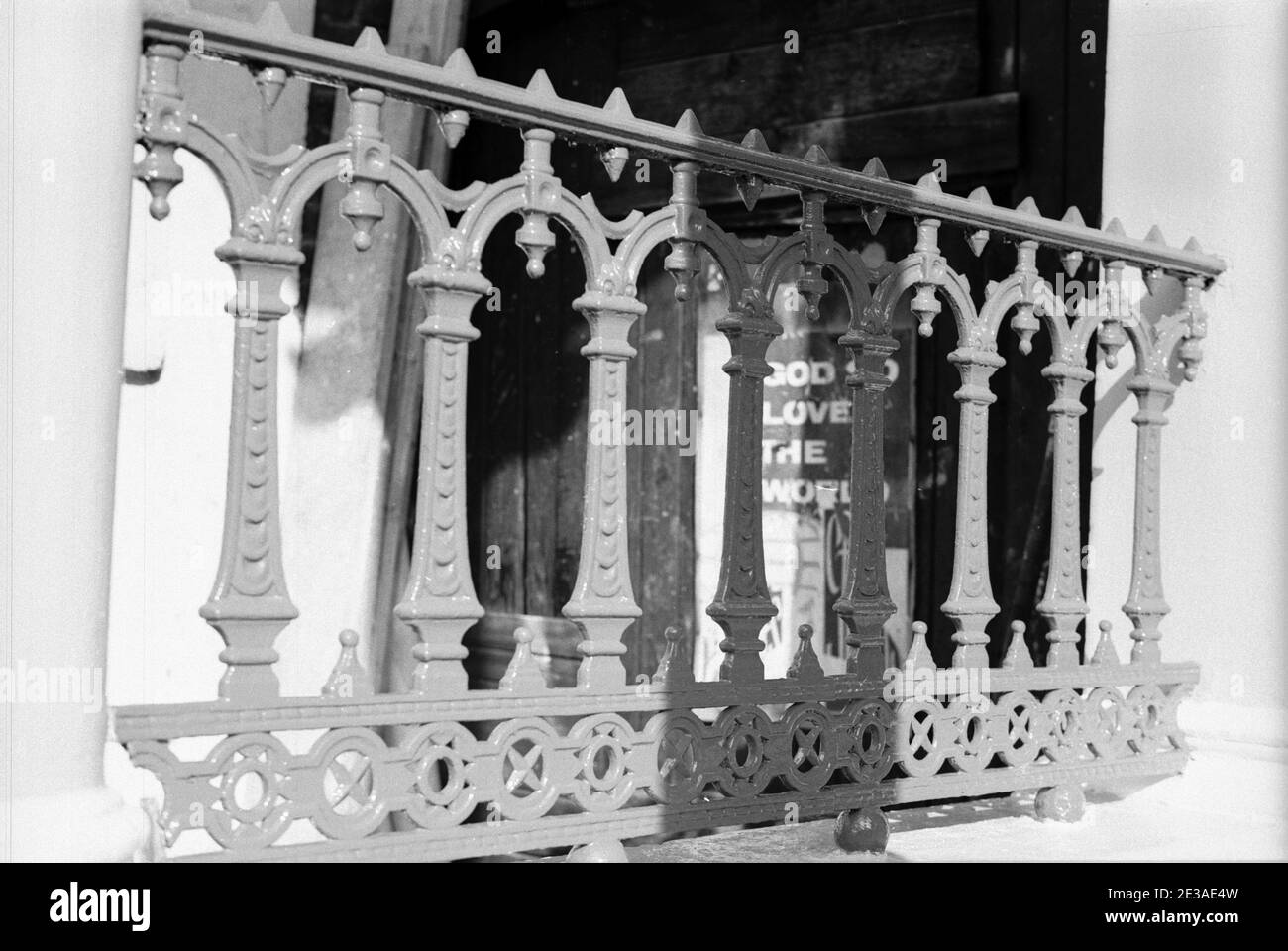 UK, West London, Notting Hill, 1973. Rundown & dilapidated large four-story houses are starting to be restored and redecorated. Cast iron railings by the house (No.9 or 10) next to the Talbot Tabernacle side entrance in Powis Gardens. Stock Photo