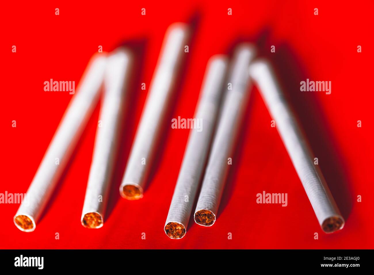 Cigarettes on a red background . Smoking bad habit Stock Photo - Alamy