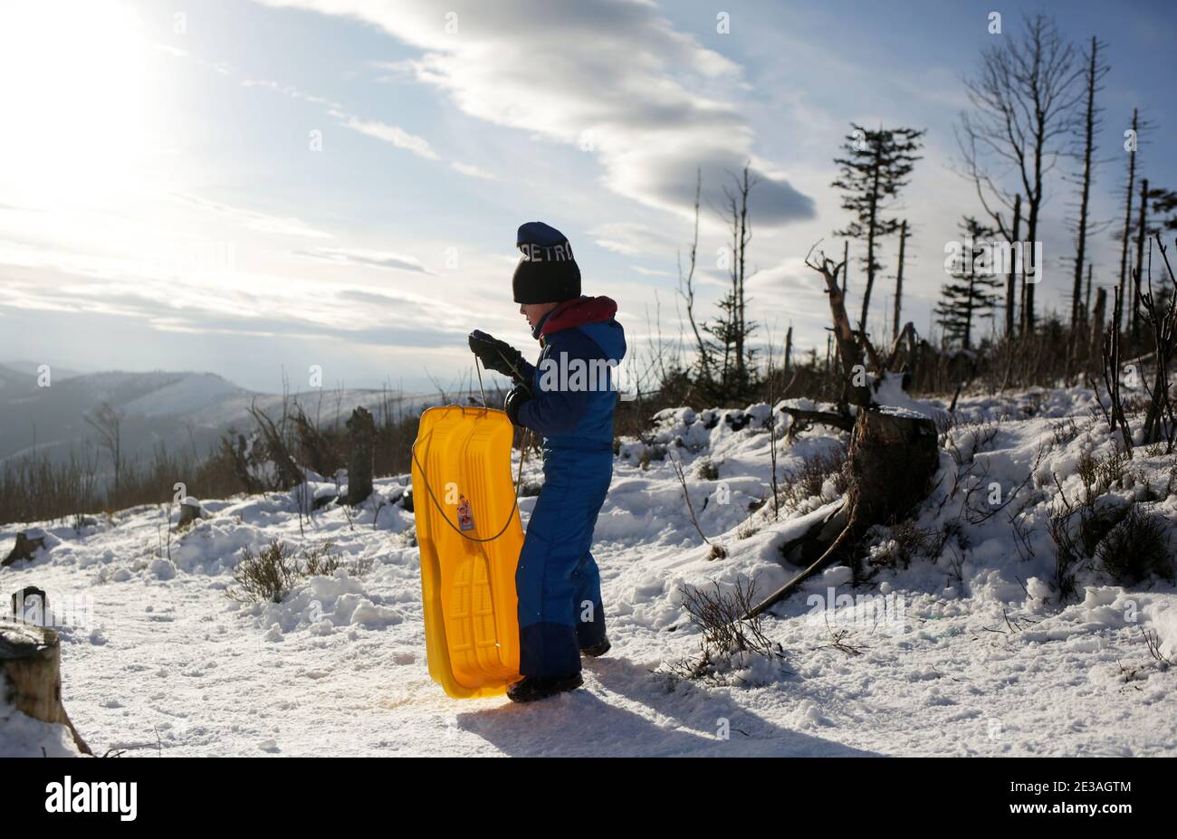 Skrzyczne, Poland - January 17, 2021: A little boy rides a sledge on the top of Skrzyczne in the Silesian Beskids Stock Photo
