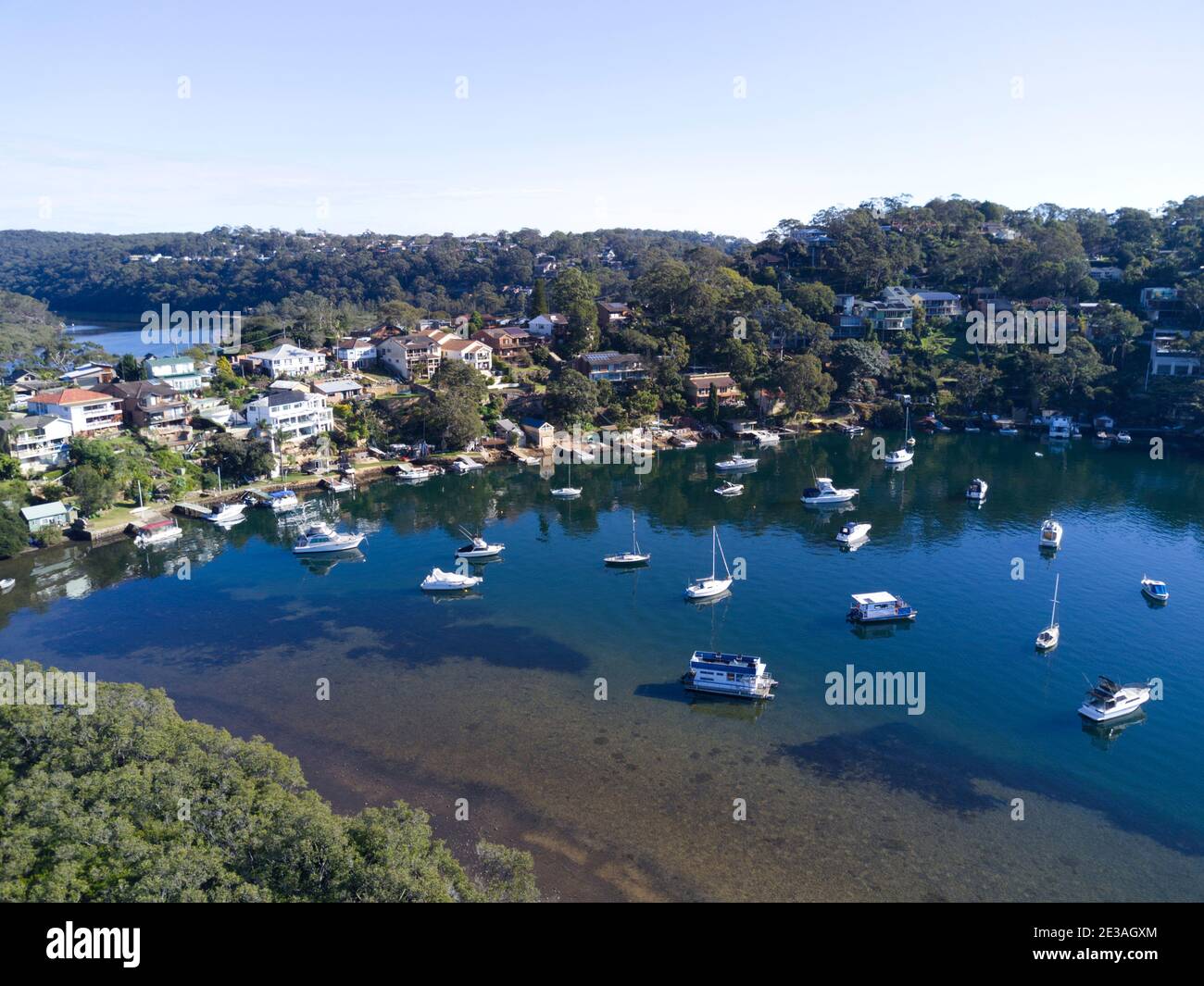 Aerial of luxury waterfront houses with private jetties on Port Hacking