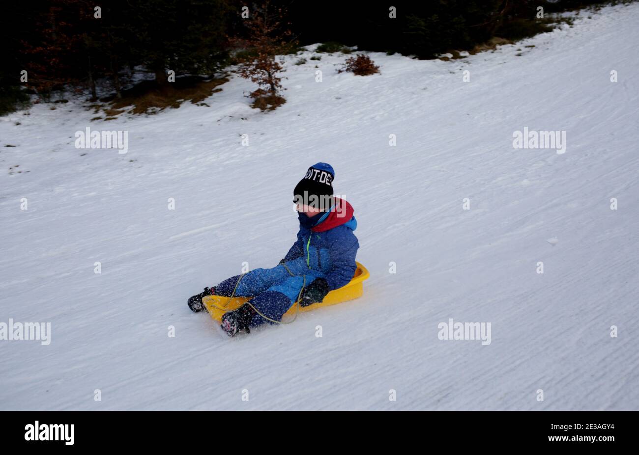 Skrzyczne, Poland - January 17, 2021: A little boy rides a sledge on the top of Skrzyczne in the Silesian Beskids Stock Photo