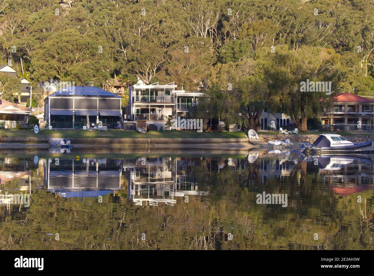 Reflections in the water of luxury waterfront houses Woronora Sutherland Shire Sydney Australia