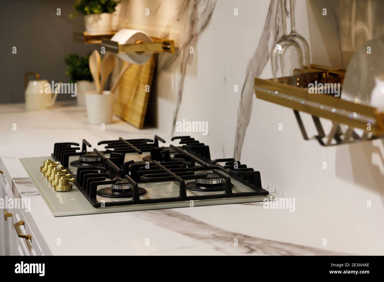 Marble kitchen countertop with a gas cooking range. Selective focus. Stock Photo
