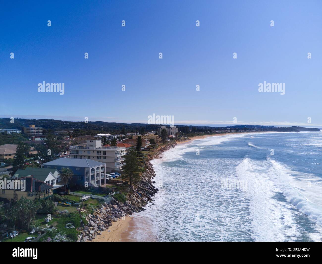 Aerial of the beach erosion in front of luxury houses and apartments at