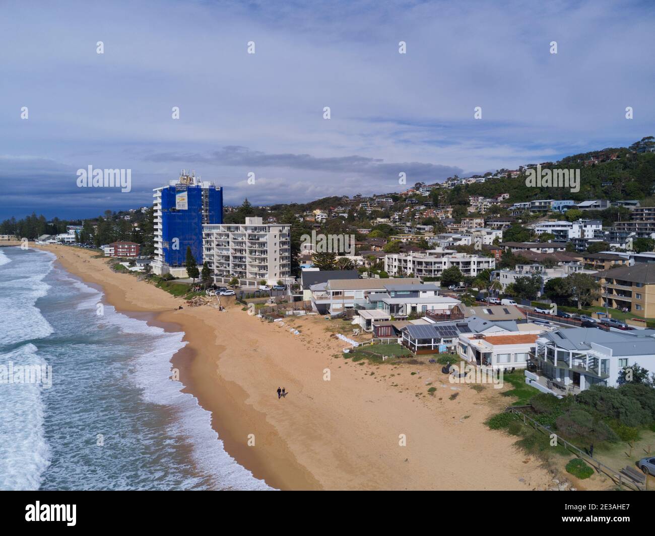 Aerial of the beach erosion in front of luxury houses and apartments at