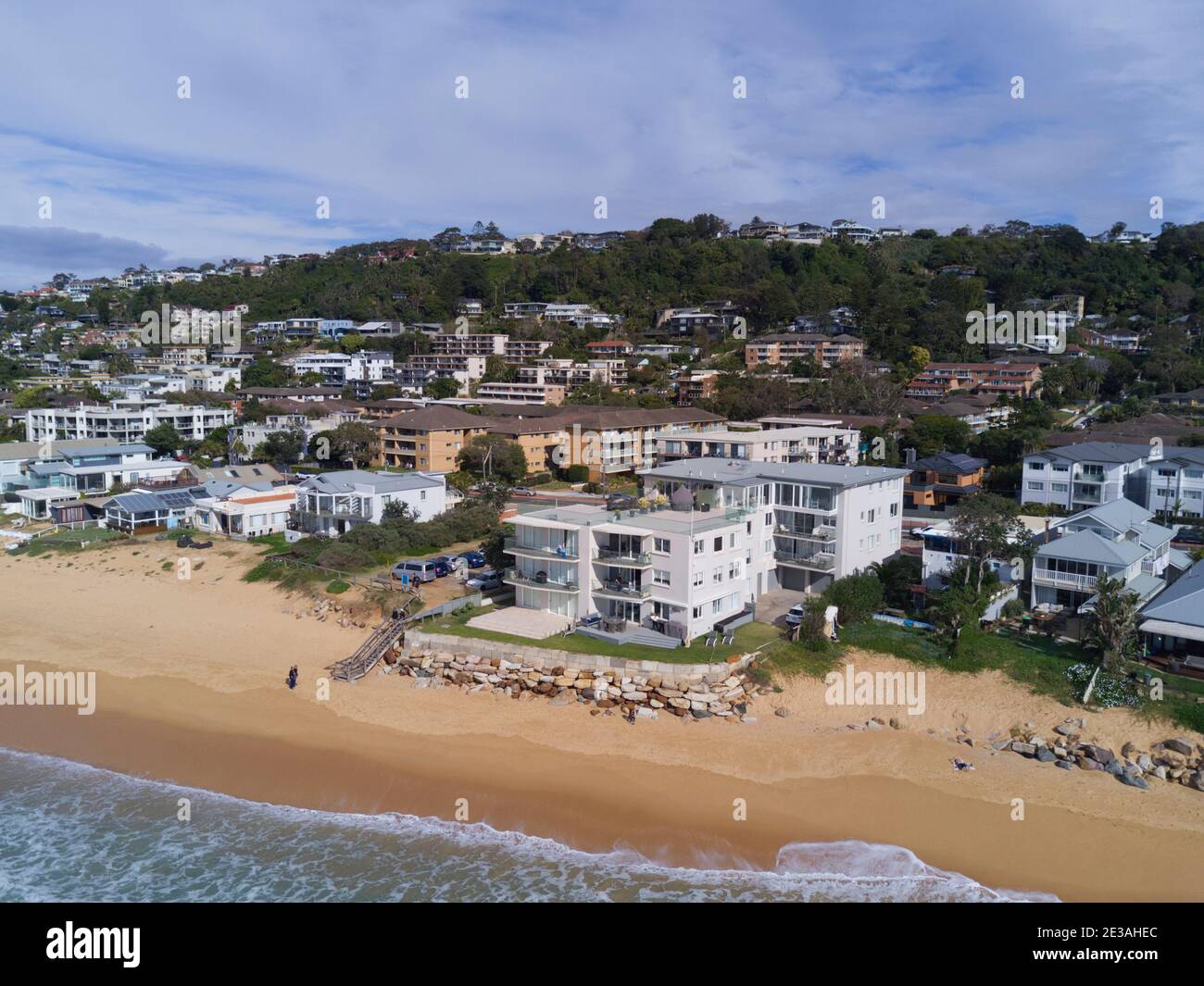 Aerial of the beach erosion in front of luxury houses and apartments at