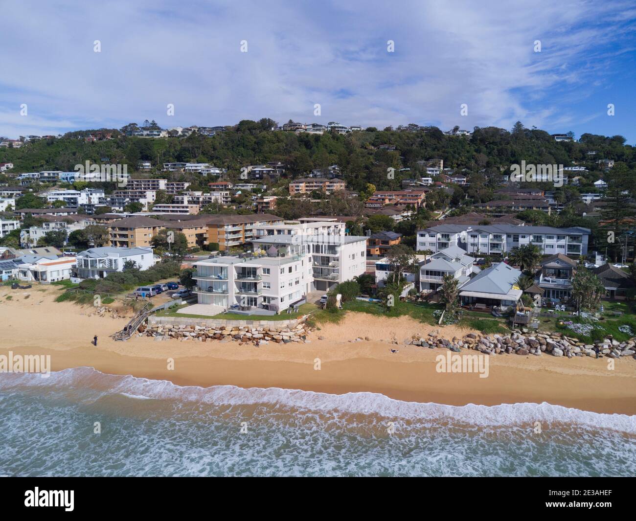 Aerial of the beach erosion in front of luxury houses and apartments at