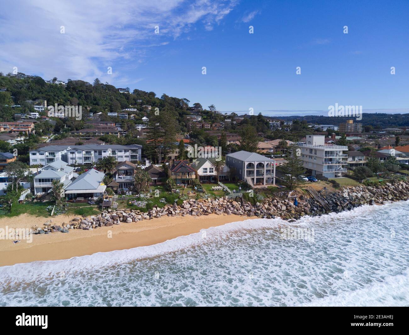 Aerial of the beach erosion in front of luxury houses and apartments at