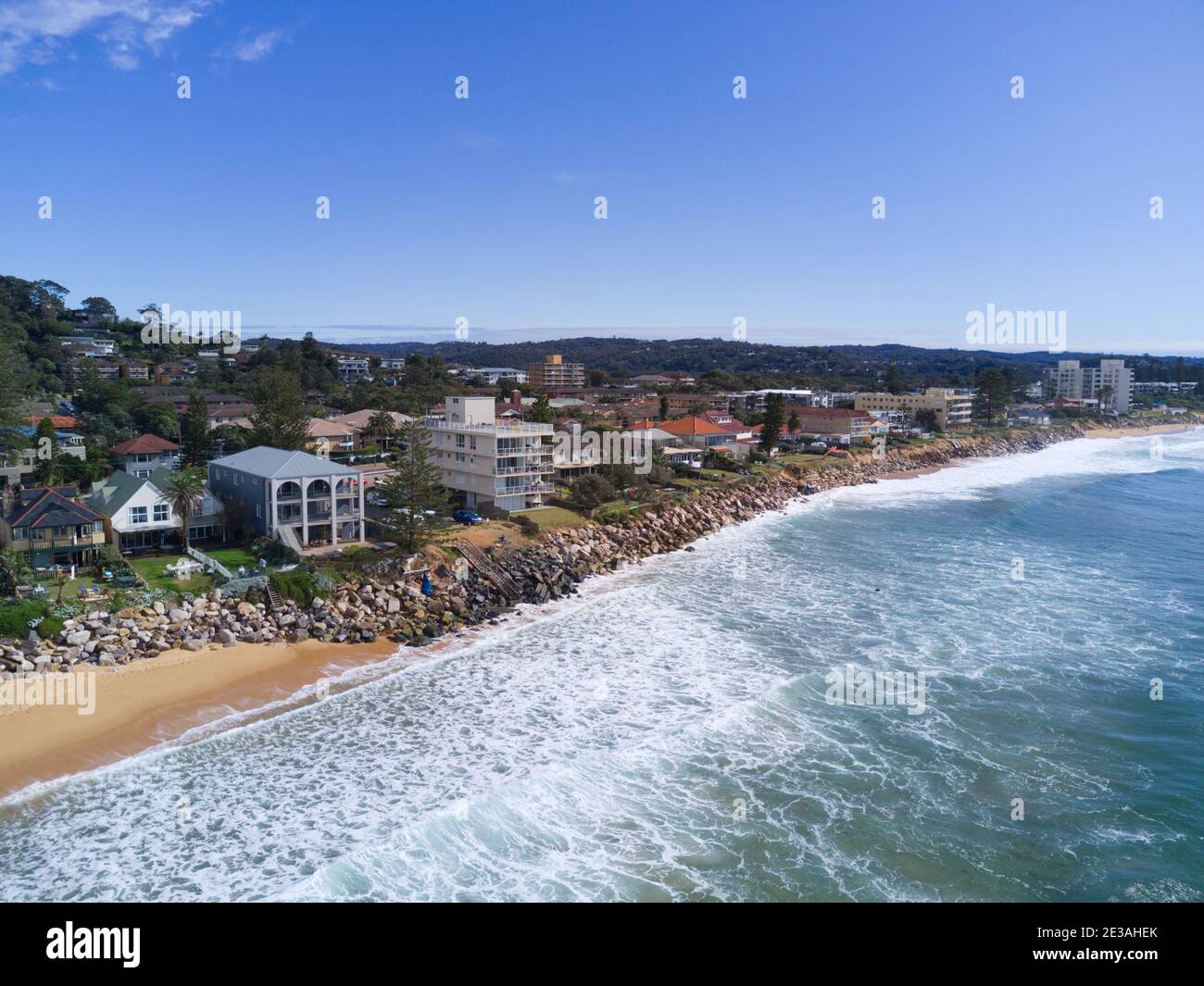 Aerial of the beach erosion in front of luxury houses and apartments at
