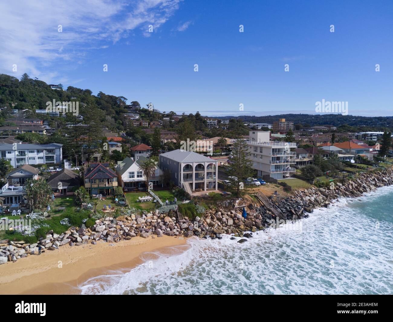 Aerial of the beach erosion in front of luxury houses and apartments at