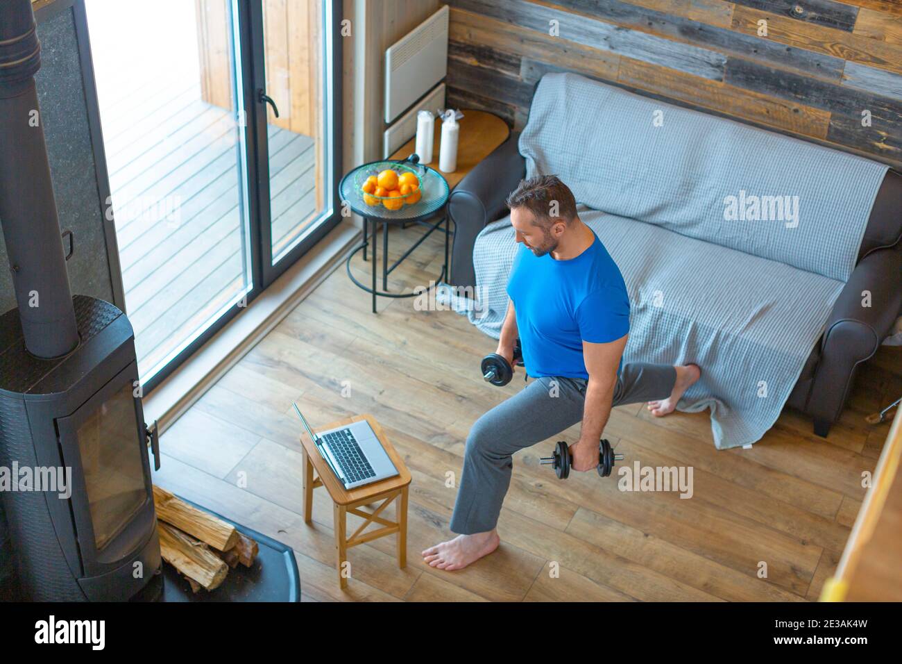 A man trains at home online using a tutorial from the