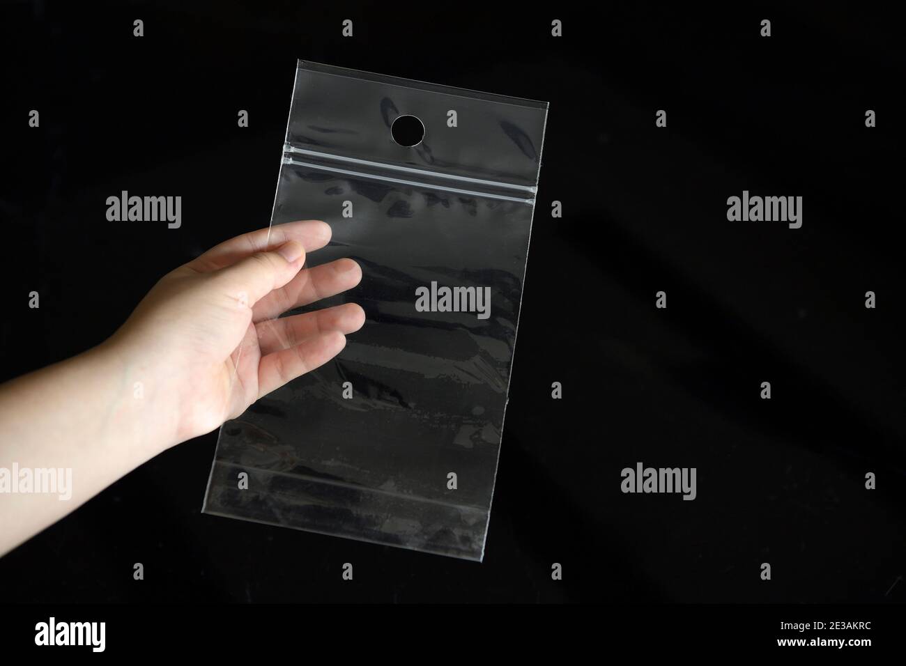 The zipper plastic bag is picked up to show transparency on a black background. Stock Photo