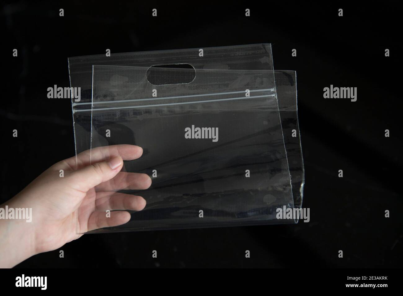 The zipper plastic bag is picked up to show transparency on a black background. Stock Photo