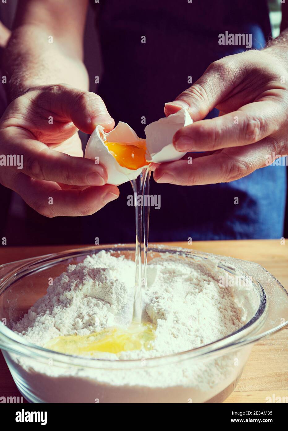 Making the dough adding eggs to the flour.Cooking process Stock Photo ...