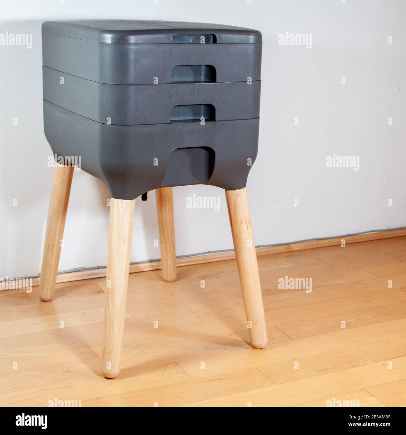 A sleek, modern looking indoor worm composter is the perfect solution for apartment living, and composting your household kitchen waste! This 3 tier w Stock Photo