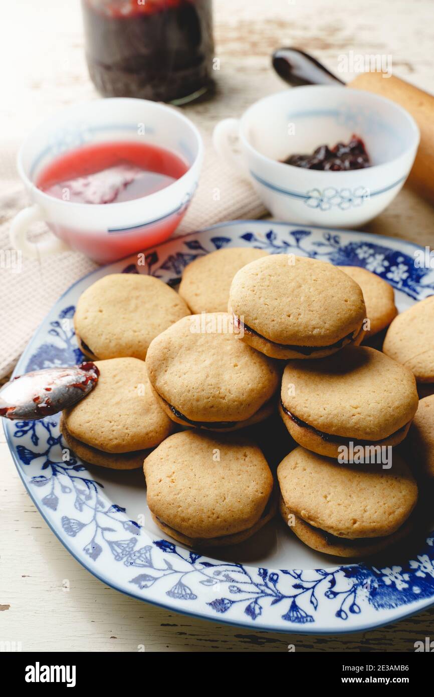 Homemade cookies with marmalade or fruit plum jam in a plate - close up front view baked sweet food traditional recipe - healthy eating concept Stock Photo