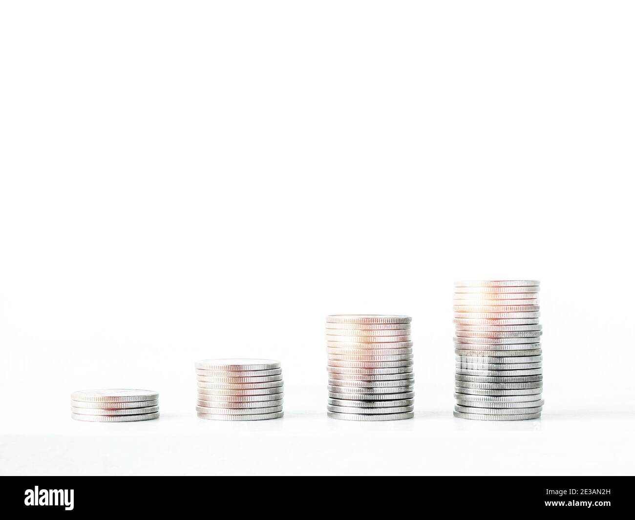 Coin stacks isolated on a white background with copy space. Piles of ...