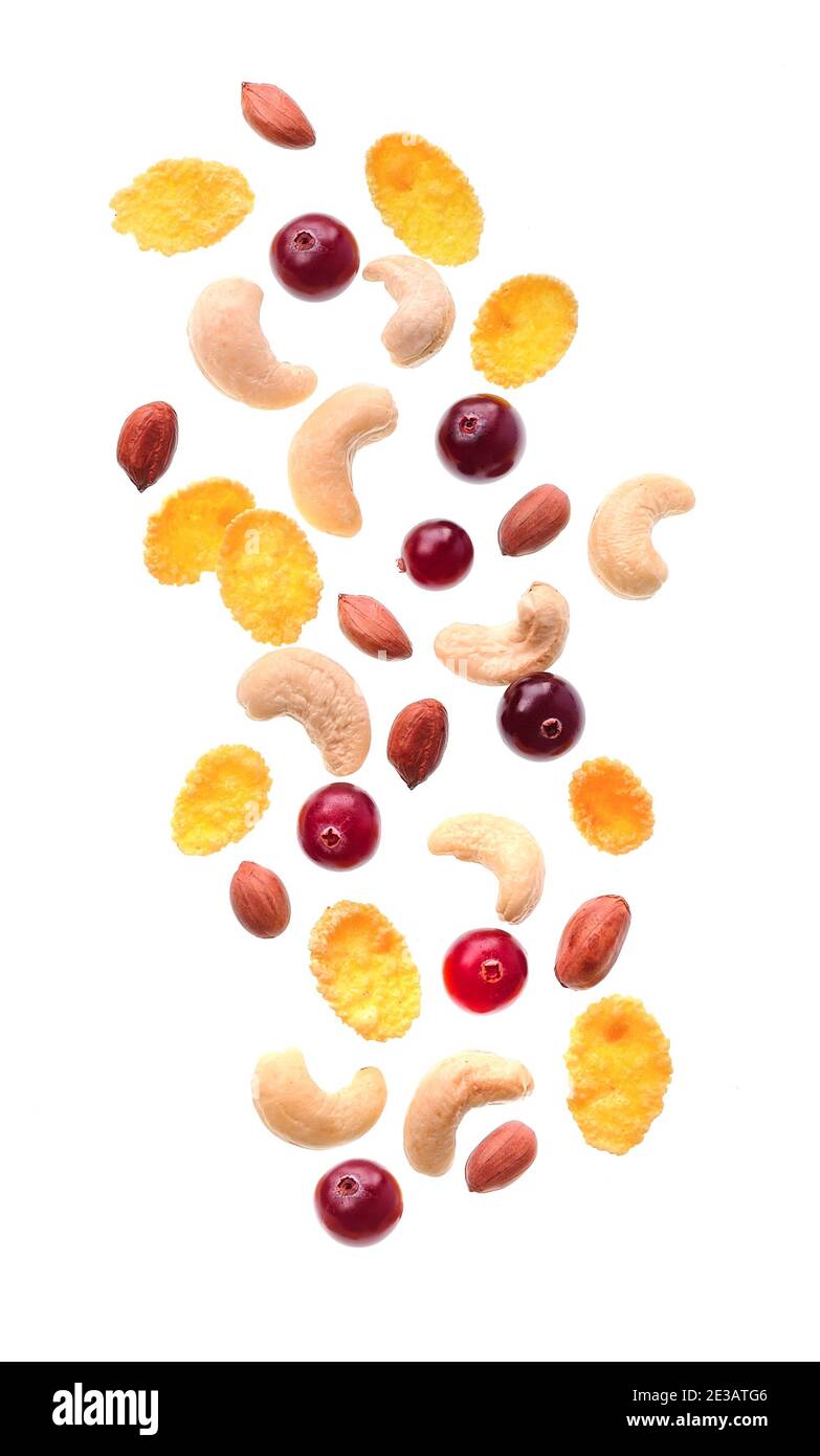 Breakfast. Falling berries with nuts and corn flax isolated on white backgrounds. Stock Photo