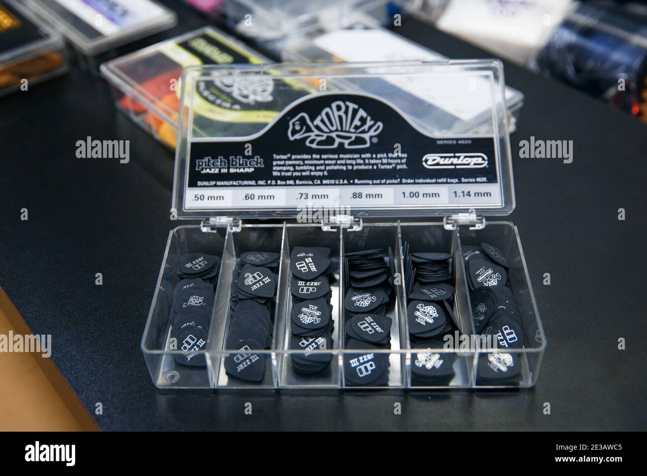 Zaporozhye,Ukraine - 14.03.2020 Black picks for playing guitar are in a transparent container. Stock Photo