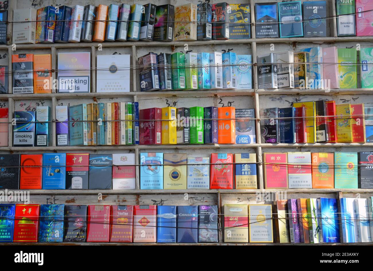 Cigarettes for sale on a street in China, lots of different brands,designs and prices. A lot of Chinese smoke so these are popular. Stock Photo