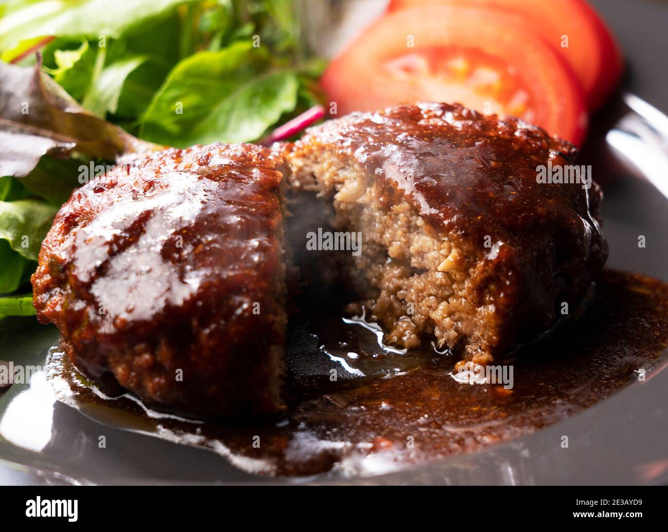 Cross section of hamburger with demiglace sauce cut in half Stock