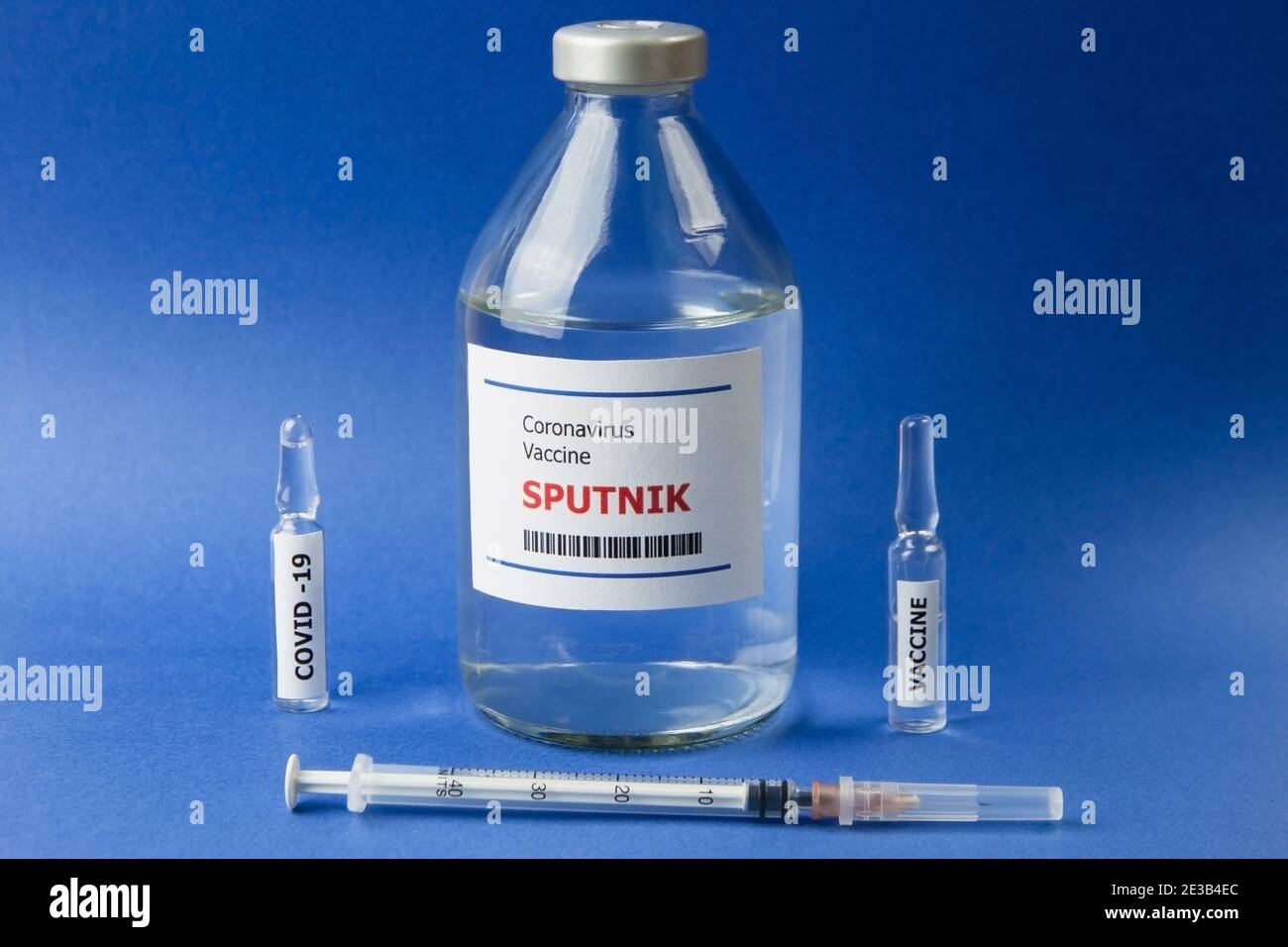 Krasnodar, Russia - January 12, 2021: Two ampoules, a syringe and a bottle  with the Sputnik vaccine from Covid-19 on a blue background Stock Photo -  Alamy