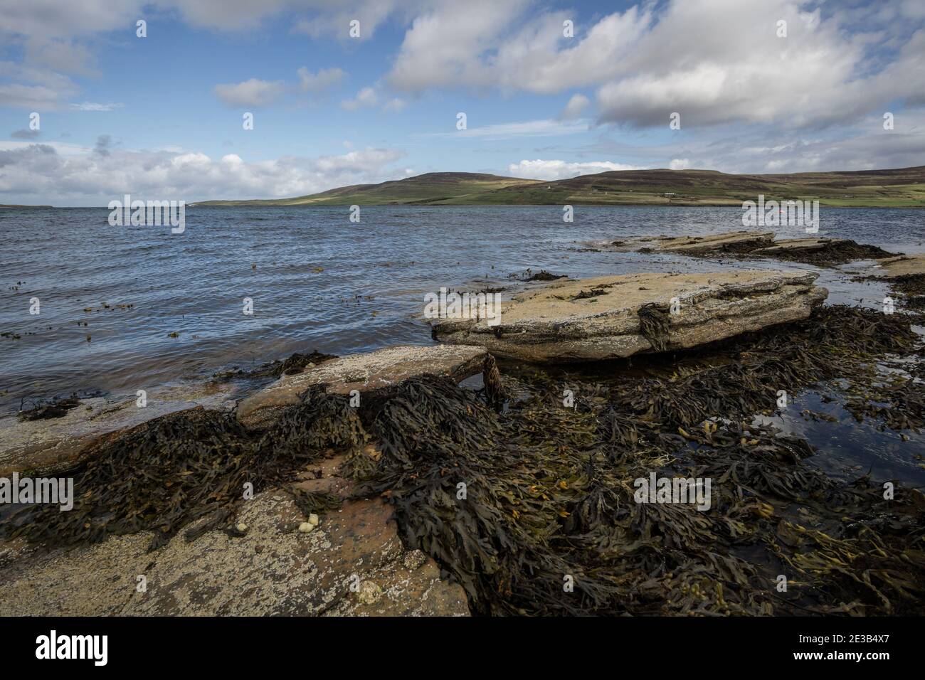 View across Eynhallow Sound from the rocks under the Broch of Gurness looking towards the island of Rousay Stock Photo