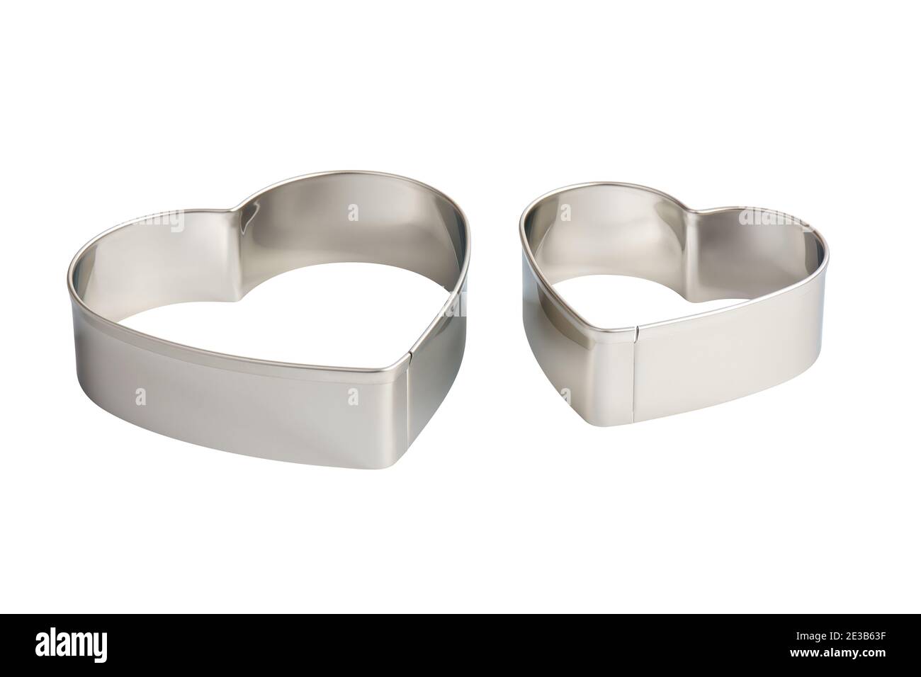 Two stainless steel heartshaped cookie cutters, isolated Stock Photo