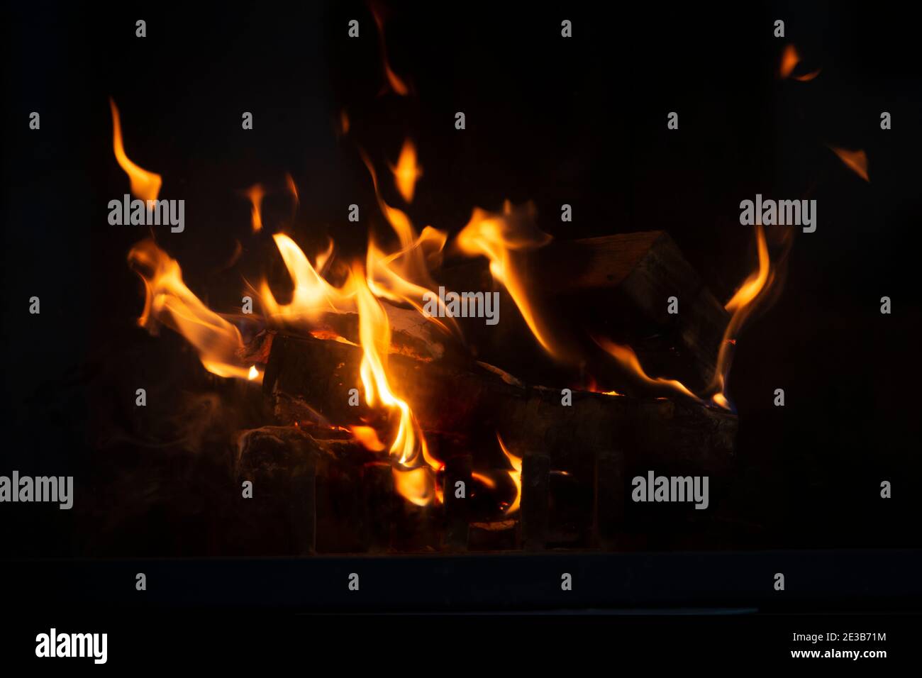 Fire flame background. Firewood burning in the fireplace. Stock Photo