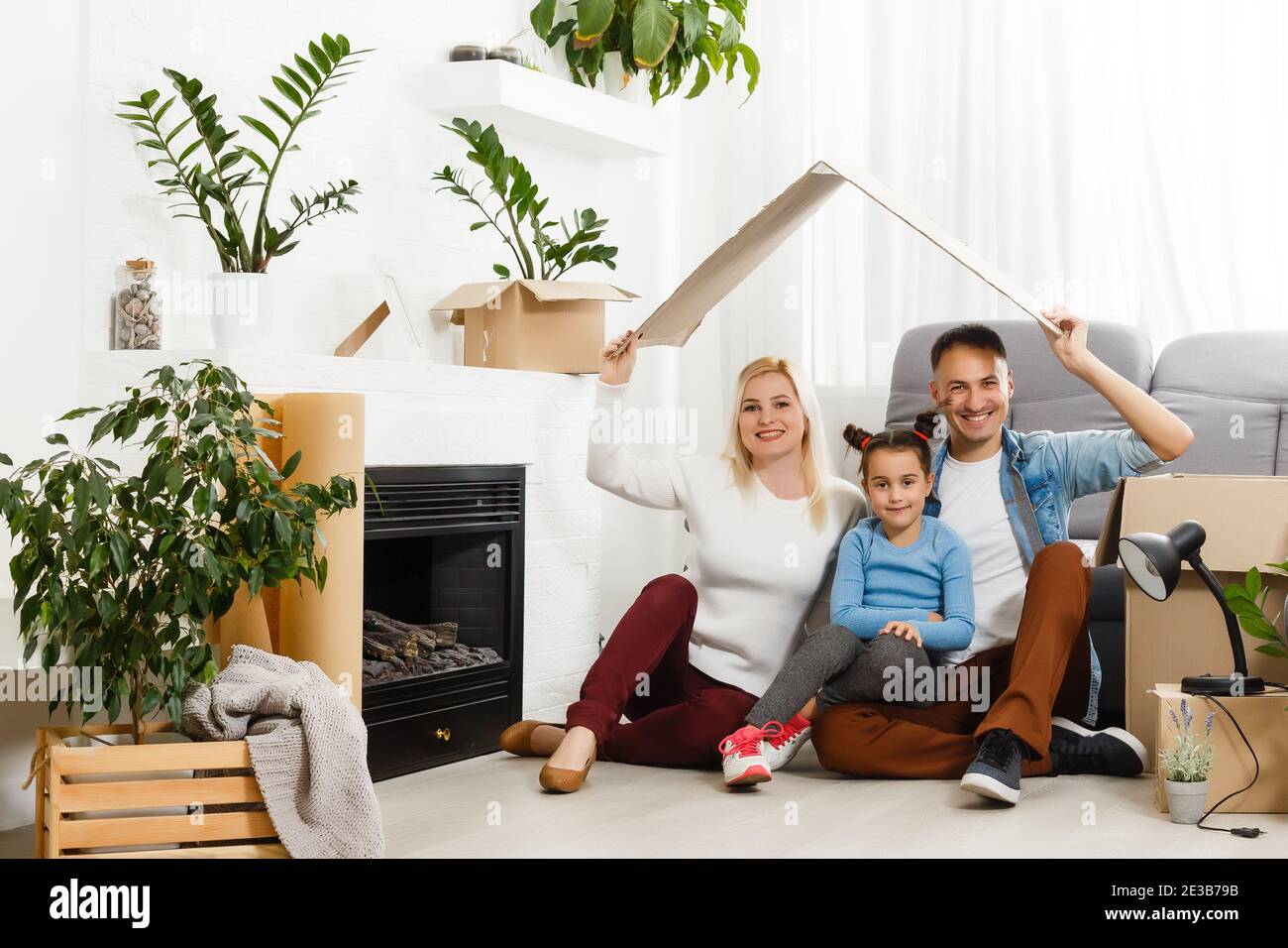 concept housing a young family. Mother father and child in new house ...