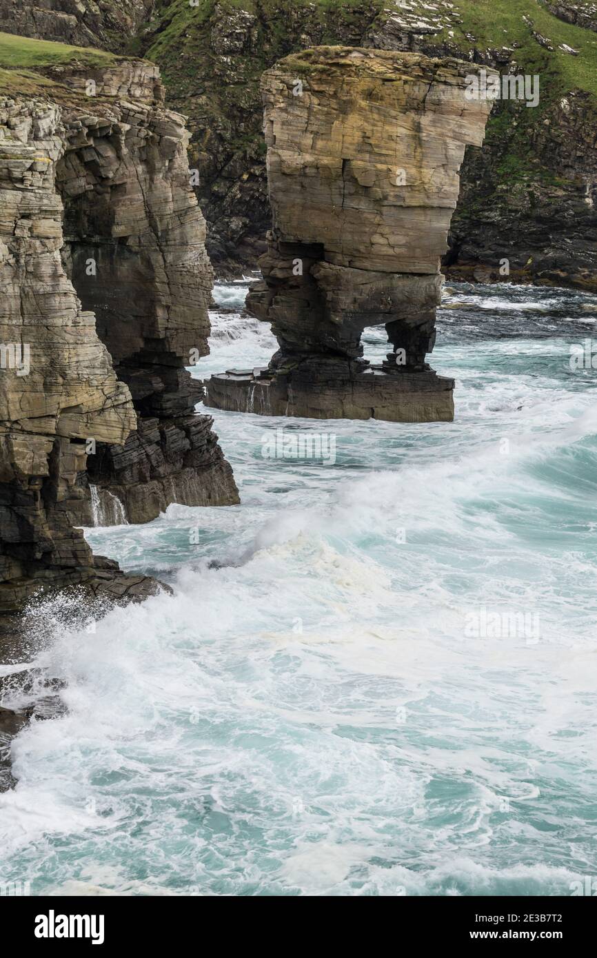 Waves crashing against the Yesnaby Castle, a famous sea stack in Sandwick, Orkney, Scotland Stock Photo