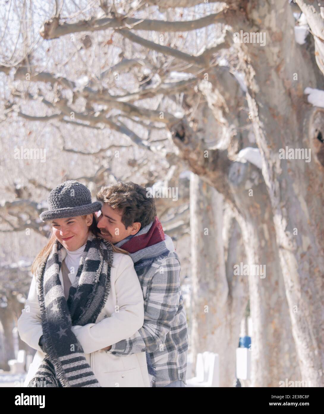 Portrait of a happy romantic couple having fun together and laughing in a snowy day. Winter Photography Outdoor 2021. Stock Photo