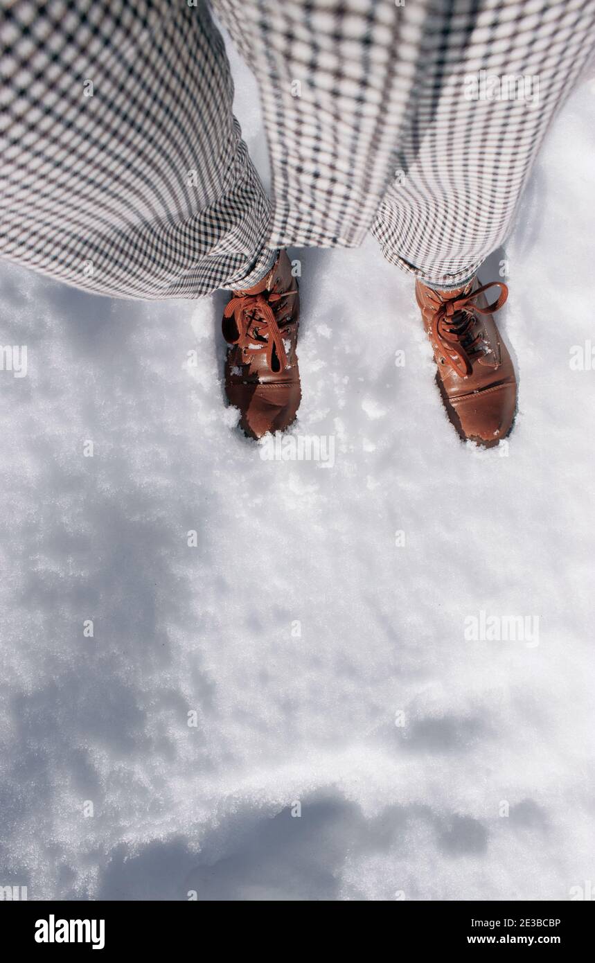 Personal view of a female feet in brown boots, winter walking in snow. Beautiful white winter weather with fresh snowfall. Winter Photography 2021. Stock Photo