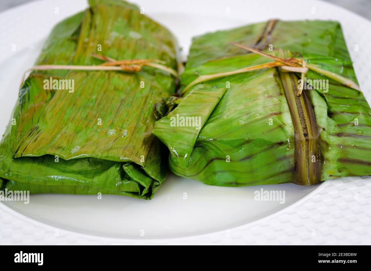 Closeup of fish covered and fried in banana leaf in traditional Kerala style (Meen Pollichathu) Stock Photo