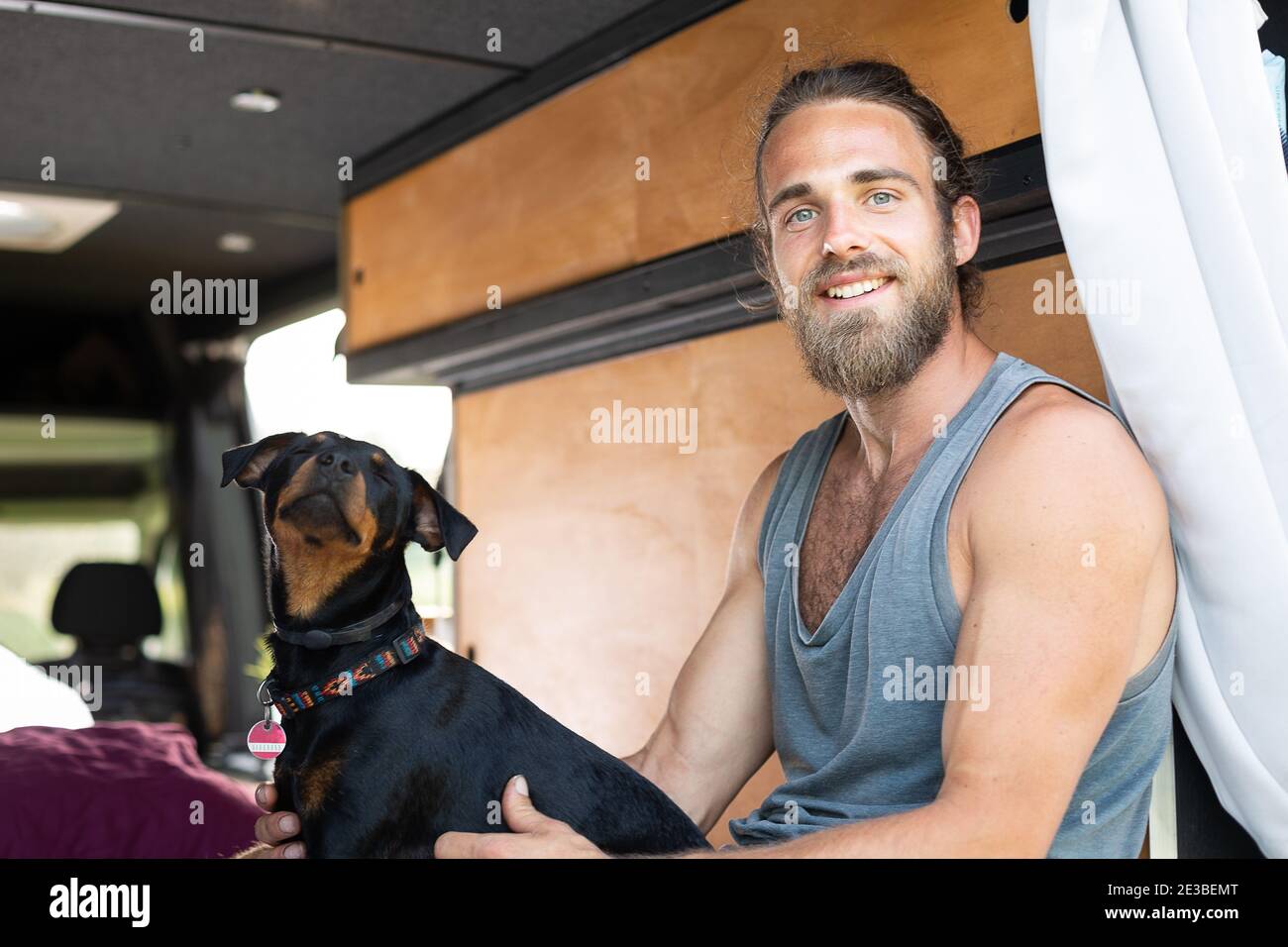 Man and his dog inside a camper van Stock Photo