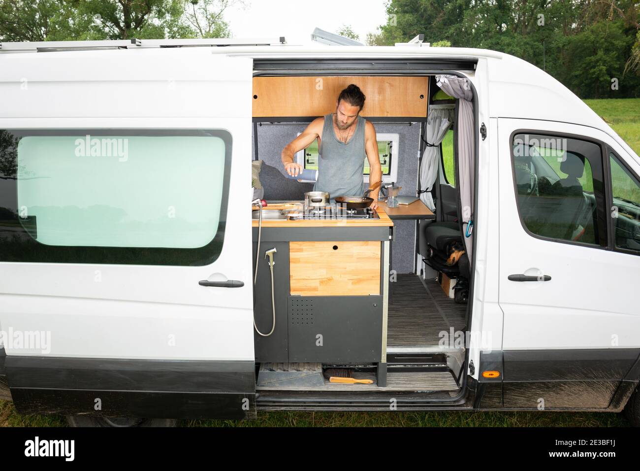 Man living in a DIY camper van Stock Photo