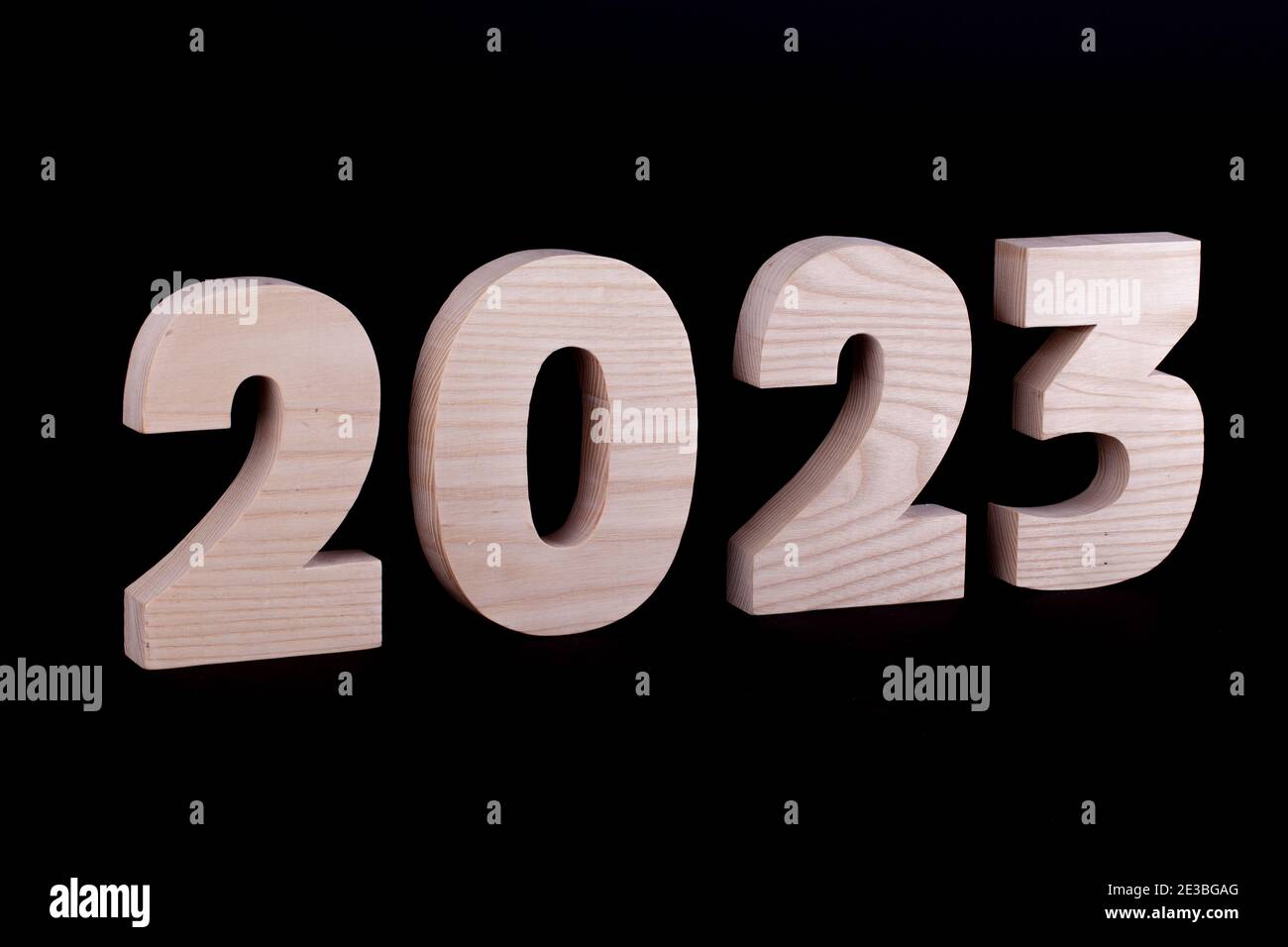 2023 year large wooden numbers. Hardwood characters on a black background Stock Photo