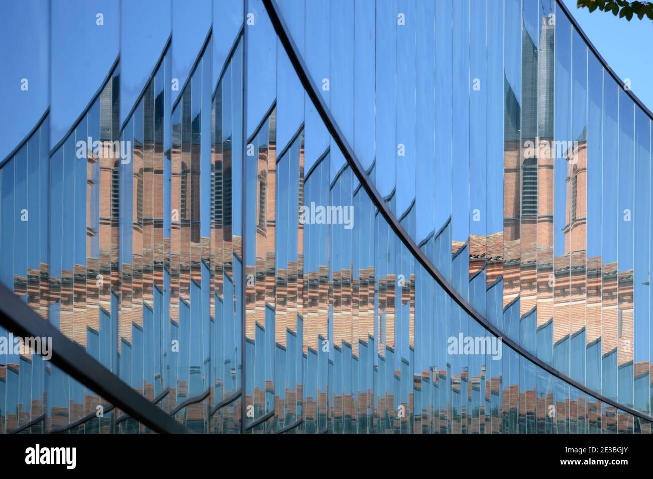 Abstract Distorted Image of the Natural History Museum with Brick Tower Reflected in Mirror Glass Modern Exteension Toulouse France Stock Photo