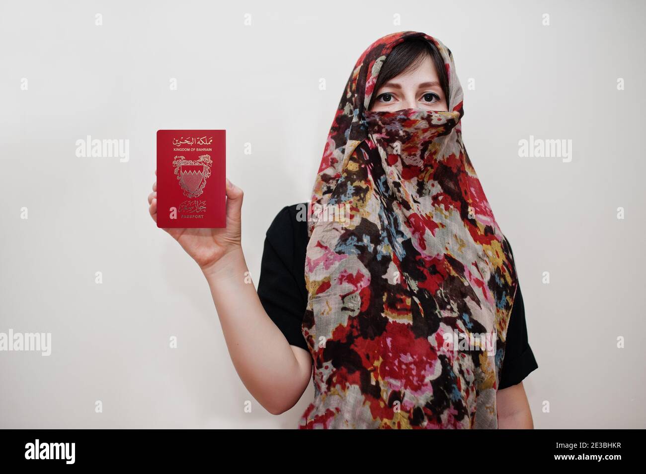 Young arabian muslim woman in hijab clothes hold Kingdom of Bahrain  passport on white wall background, studio portrait Stock Photo - Alamy